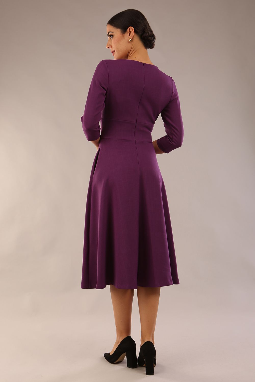 model is wearing diva catwalk casares swing dress with a keyhole neckline three quarter sleeve dress with pocket detail in imperial purple side front (Imperial Purple)