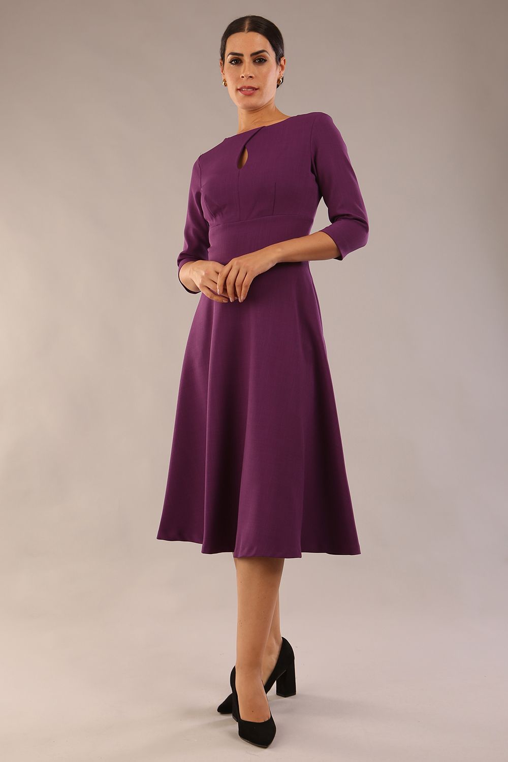 model is wearing diva catwalk casares swing dress with a keyhole neckline three quarter sleeve dress with pocket detail in imperial purple side front (Imperial Purple)