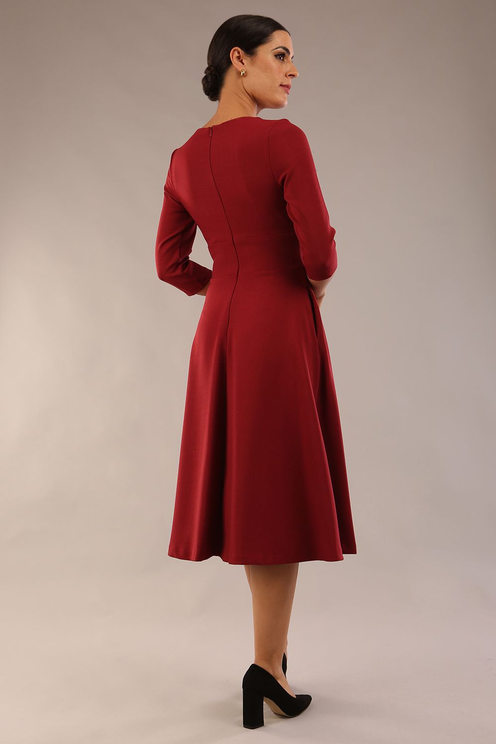 Brunette model is wearing diva catwalk casares swing dress with a keyhole neckline three quarter sleeve dress with pocket detail in Wine front side (Wine)