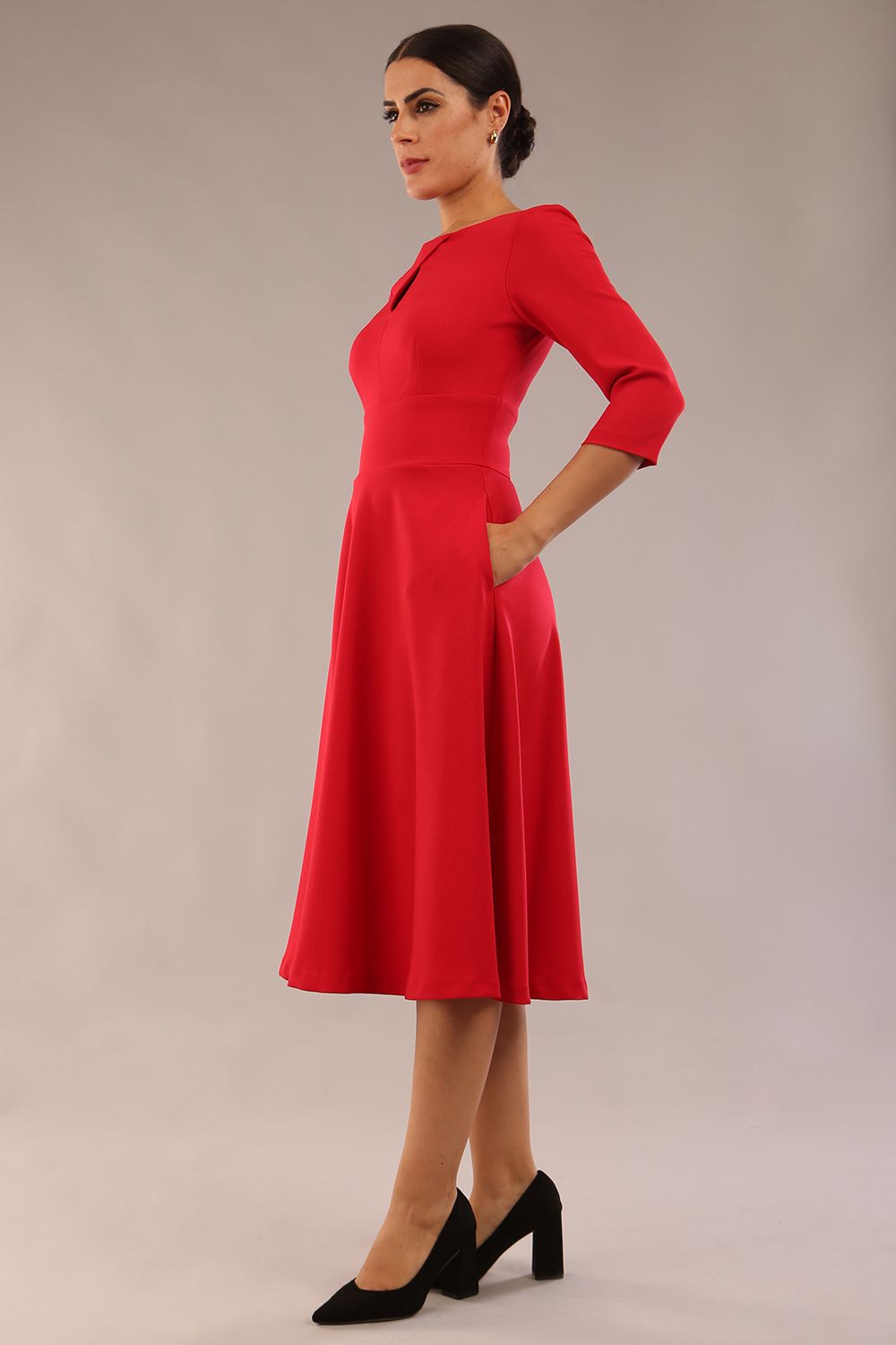 Brunette model is wearing diva catwalk casares swing dress with a keyhole neckline three quarter sleeve dress with pocket detail in red front (Scarlet Red)