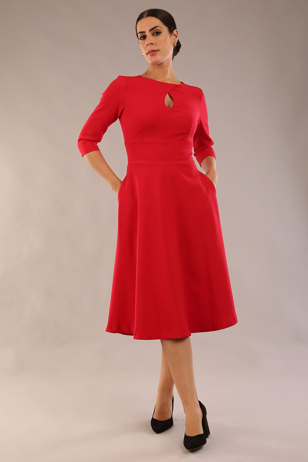 Brunette model is wearing diva catwalk casares swing dress with a keyhole neckline three quarter sleeve dress with pocket detail in red front (Scarlet Red)