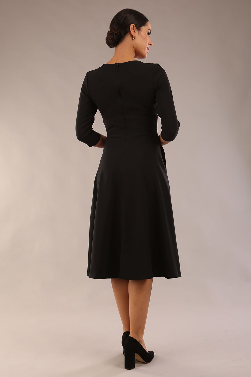 Brunette model is wearing diva catwalk casares swing dress with a keyhole neckline three quarter sleeve dress with pocket detail in black front (Black)