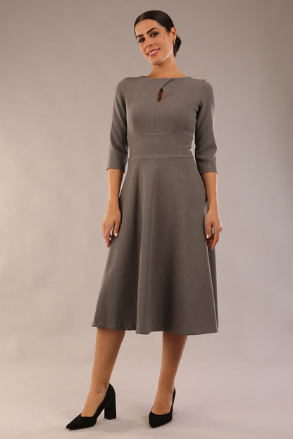Brunette model is wearing diva catwalk casares swing dress with a keyhole neckline three quarter sleeve dress with pocket detail in Castlerock Grey  front (Castlerock Grey)