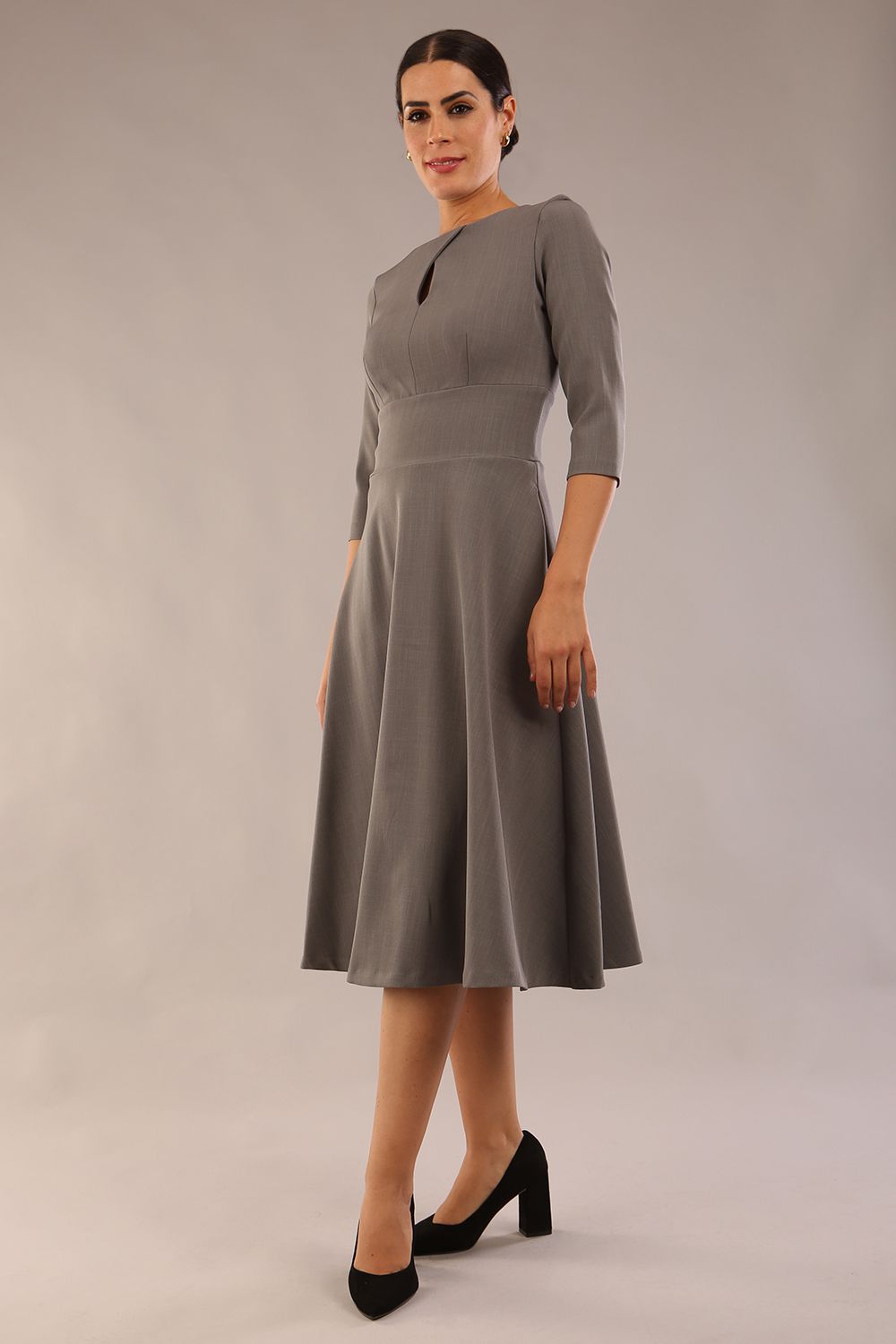 Brunette model is wearing diva catwalk casares swing dress with a keyhole neckline three quarter sleeve dress with pocket detail in Castlerock Grey  front (Castlerock Grey)