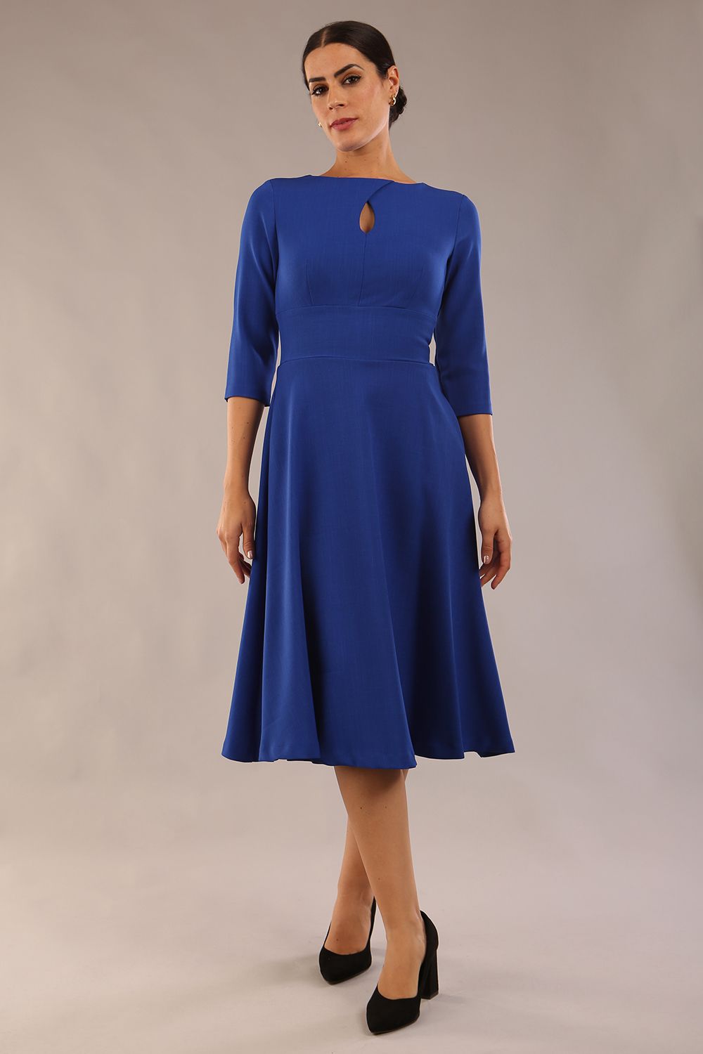 Brunette model is wearing diva catwalk casares swing dress with a keyhole neckline three quarter sleeve dress with pocket detail in cobalt blue front (Cobalt Blue)