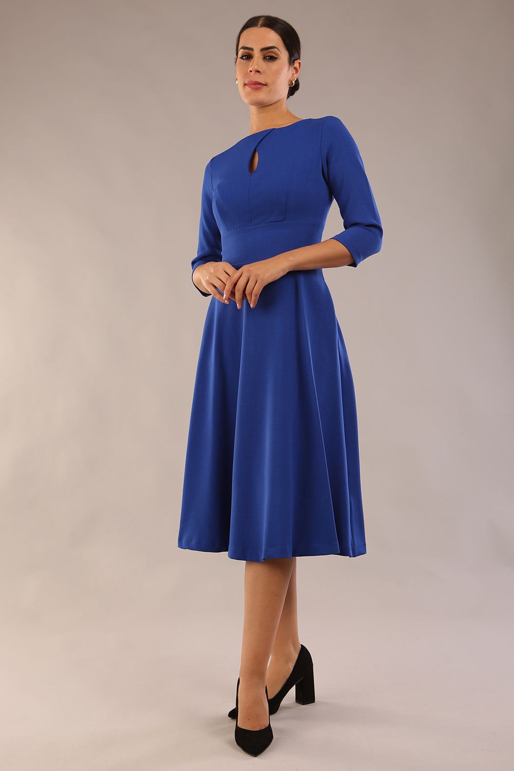 Brunette model is wearing diva catwalk casares swing dress with a keyhole neckline three quarter sleeve dress with pocket detail in cobalt blue front (Cobalt Blue)