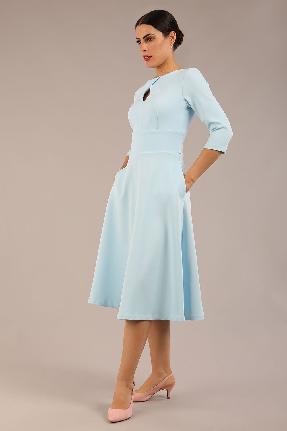 Brunette model is wearing diva catwalk casares swing dress with a keyhole neckline three quarter sleeve dress with pocket detail in sky blue front (Sky Blue)