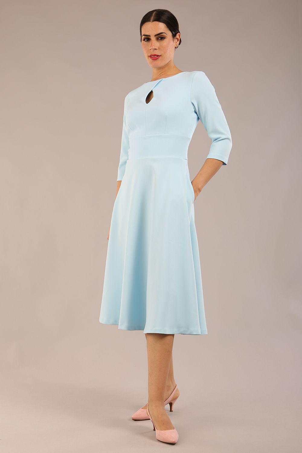 Brunette model is wearing diva catwalk casares swing dress with a keyhole neckline three quarter sleeve dress with pocket detail in sky blue front (Sky Blue)