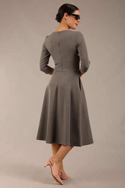 model is wearing diva catwalk casares swing dress with a keyhole neckline three quarter sleeve dress with pocket detail in Castlerock Grey  front (Castlerock Grey)