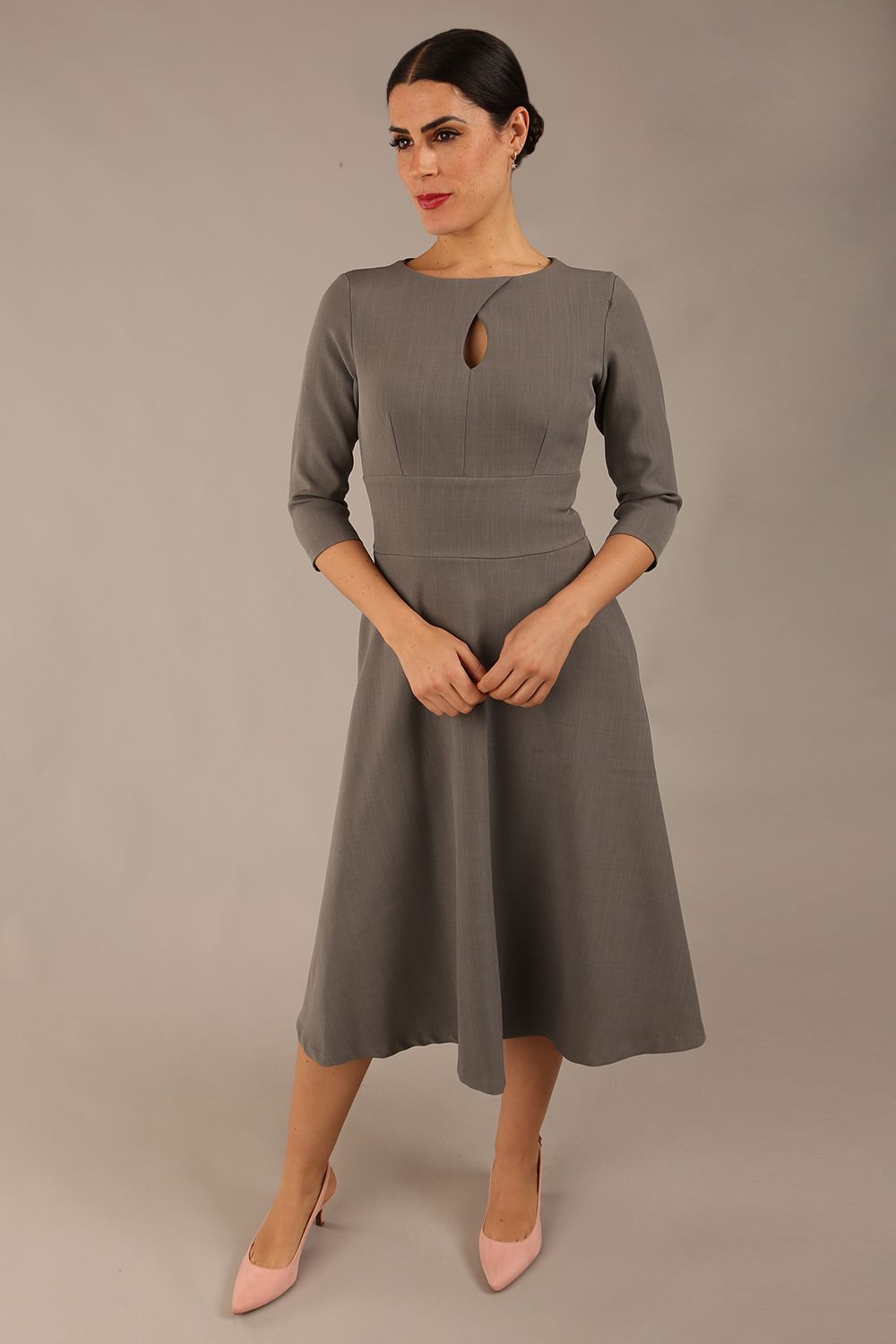 Brunette model is wearing diva catwalk casares swing dress with a keyhole neckline three quarter sleeve dress with pocket detail in Castlerock Grey  front (Castlerock Grey)