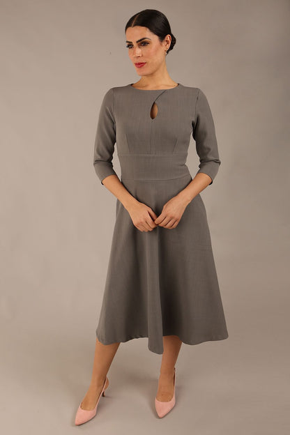 Brunette model is wearing diva catwalk casares swing dress with a keyhole neckline three quarter sleeve dress with pocket detail in Castlerock Grey  front (Castlerock Grey)