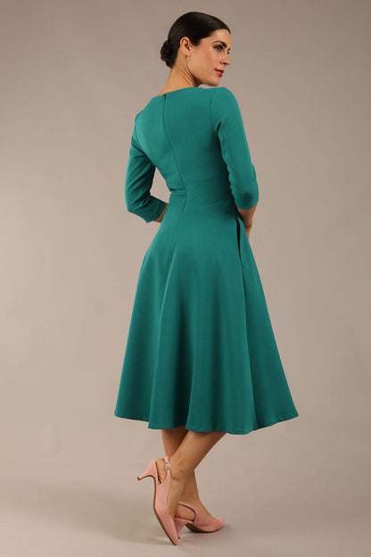 model is wearing diva catwalk casares swing dress with a keyhole neckline three quarter sleeve dress with pocket detail in Parasailing green front (Parasailing Green)