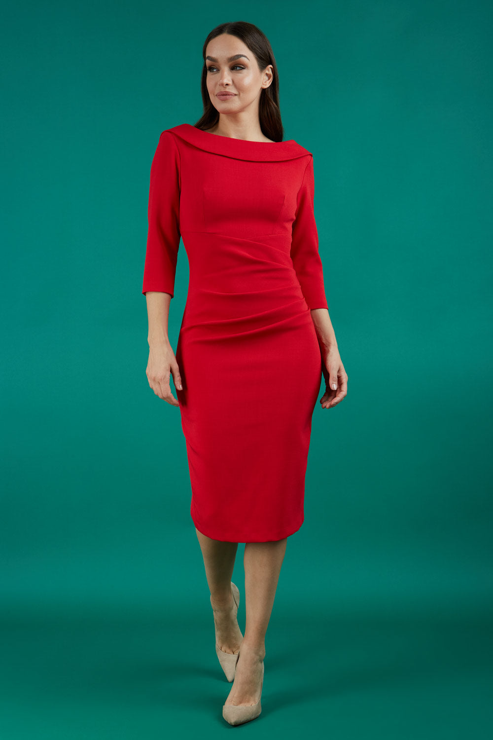 A brunette model is wearing a round neckline pencil dress with pleating on the tummy area in red front image