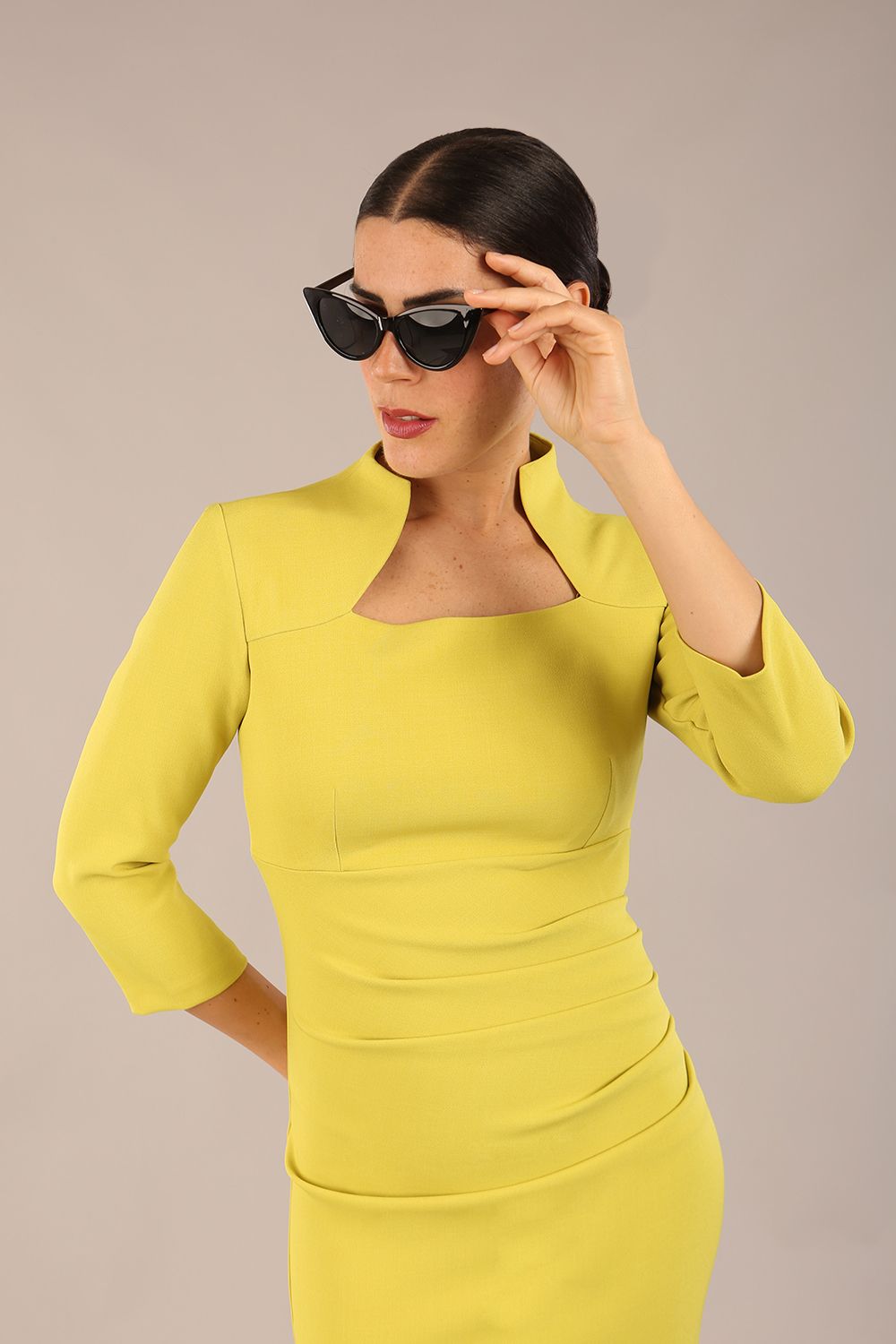model is wearing diva catwalk plaza sheath dress with high neck Trapezium neckline cutout and three quarter sleeve pretty dress in citrus green front