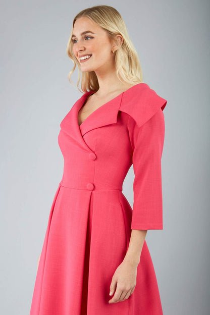 model is wearing diva catwalk gatsby swing dress with pocket detail and wide v-neck collar and buttons down the front panel in hibiscus pink front