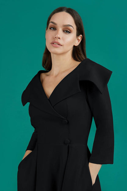 model is wearing diva catwalk gatsby swing dress with pocket detail and wide v-neck collar and buttons down the front panel in black front