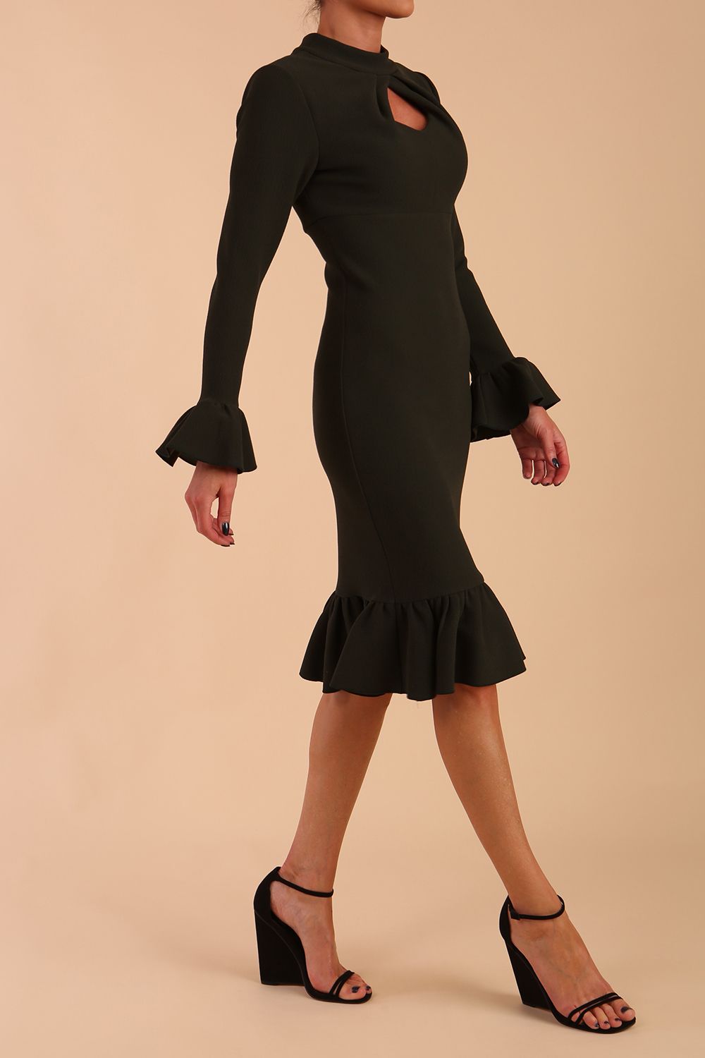 Model wearing Macarena Peplum Hem Bodycon Pencil Dress with Long sleeves with peplum details at the ends and High neckline with overlapping keyhole detail in Obsidian Green colour front side