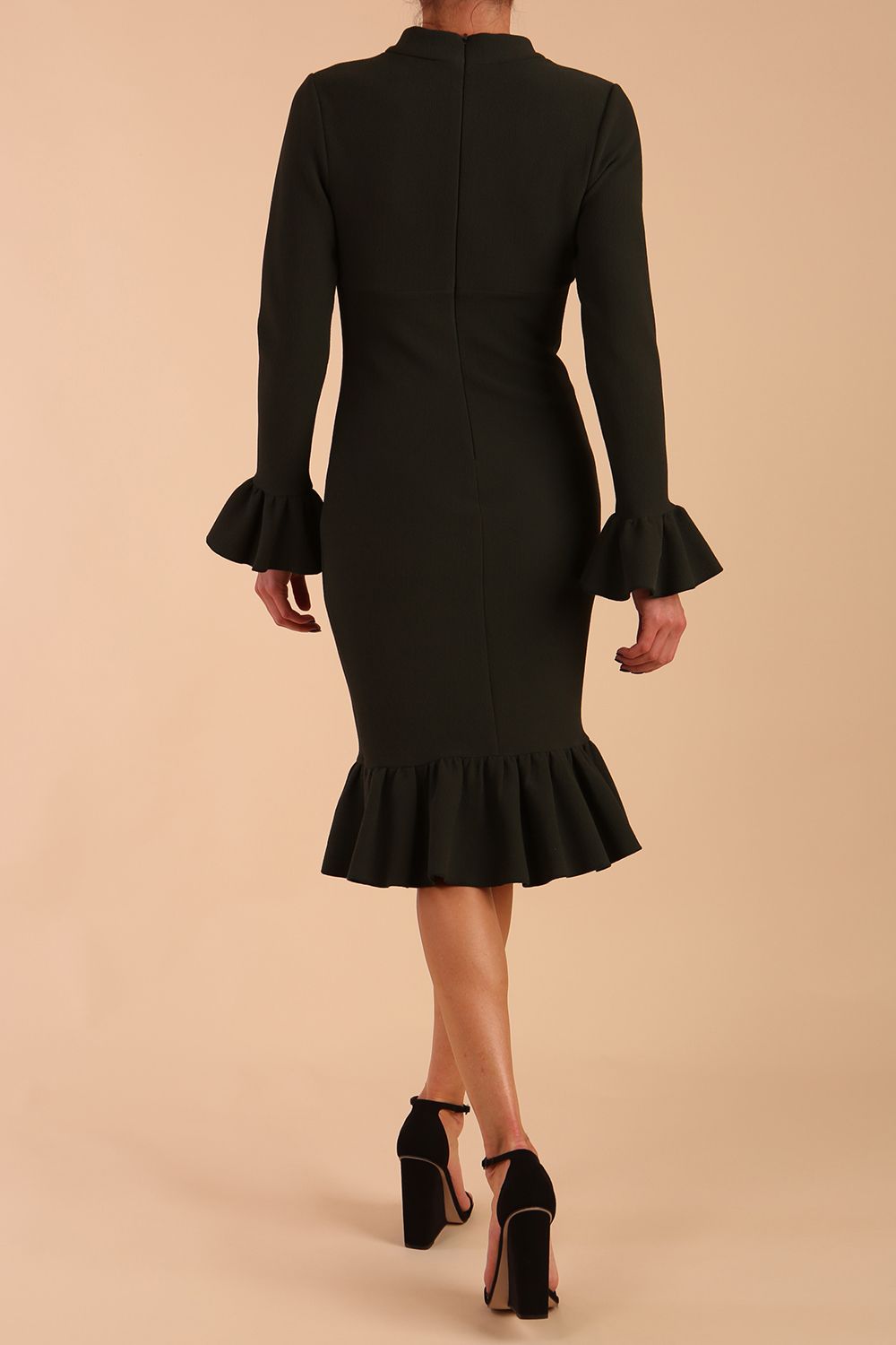 Model wearing Macarena Peplum Hem Bodycon Pencil Dress with Long sleeves with peplum details at the ends and High neckline with overlapping keyhole detail in Obsidian Green colour front side