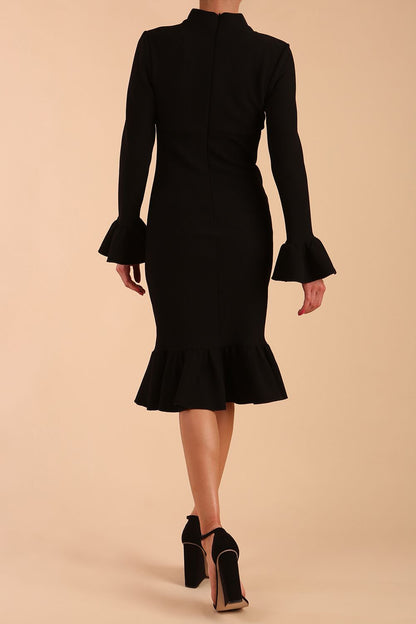 Model wearing Macarena Peplum Hem Bodycon Pencil Dress with Long sleeves with peplum details at the ends and High neckline with overlapping keyhole detail in Black colour front side