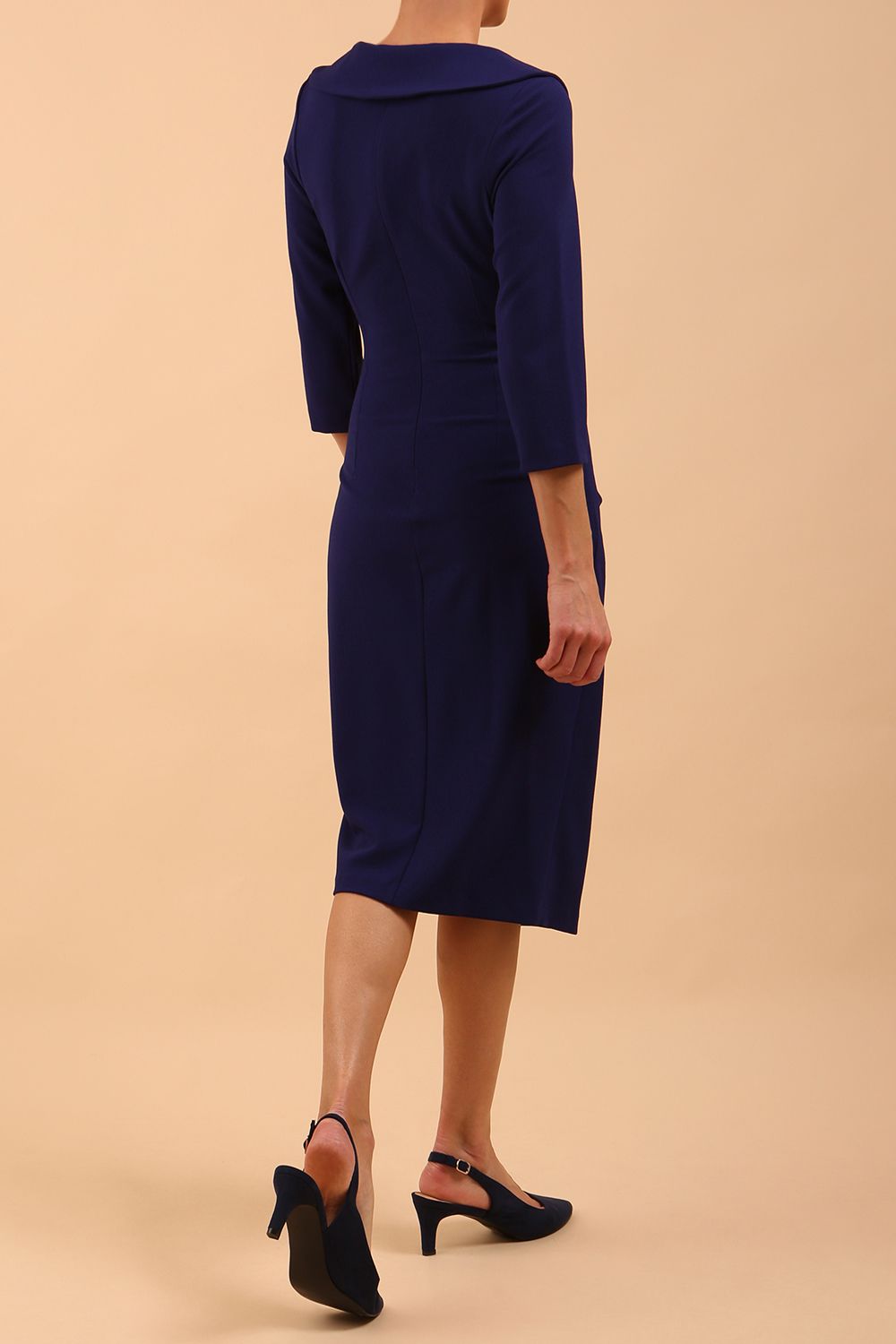  model is wearing diva catwalk liesel wrap pencil sleeved dress with collar half way around low v-neck in oxford blue front
