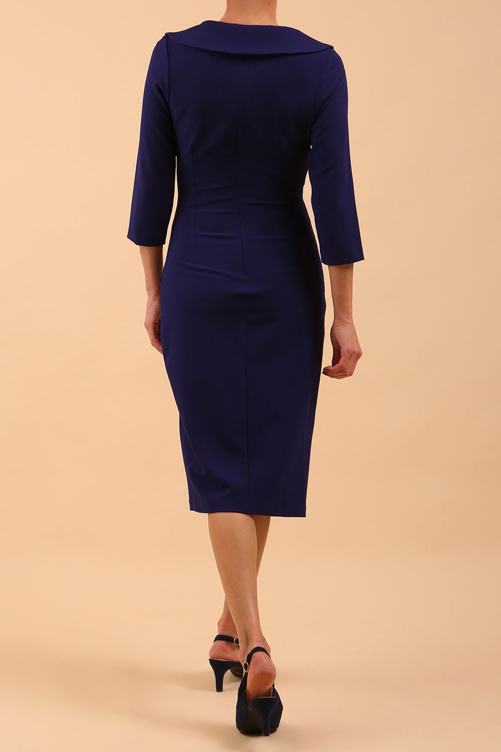  model is wearing diva catwalk liesel wrap pencil sleeved dress with collar half way around low v-neck in oxford blue front