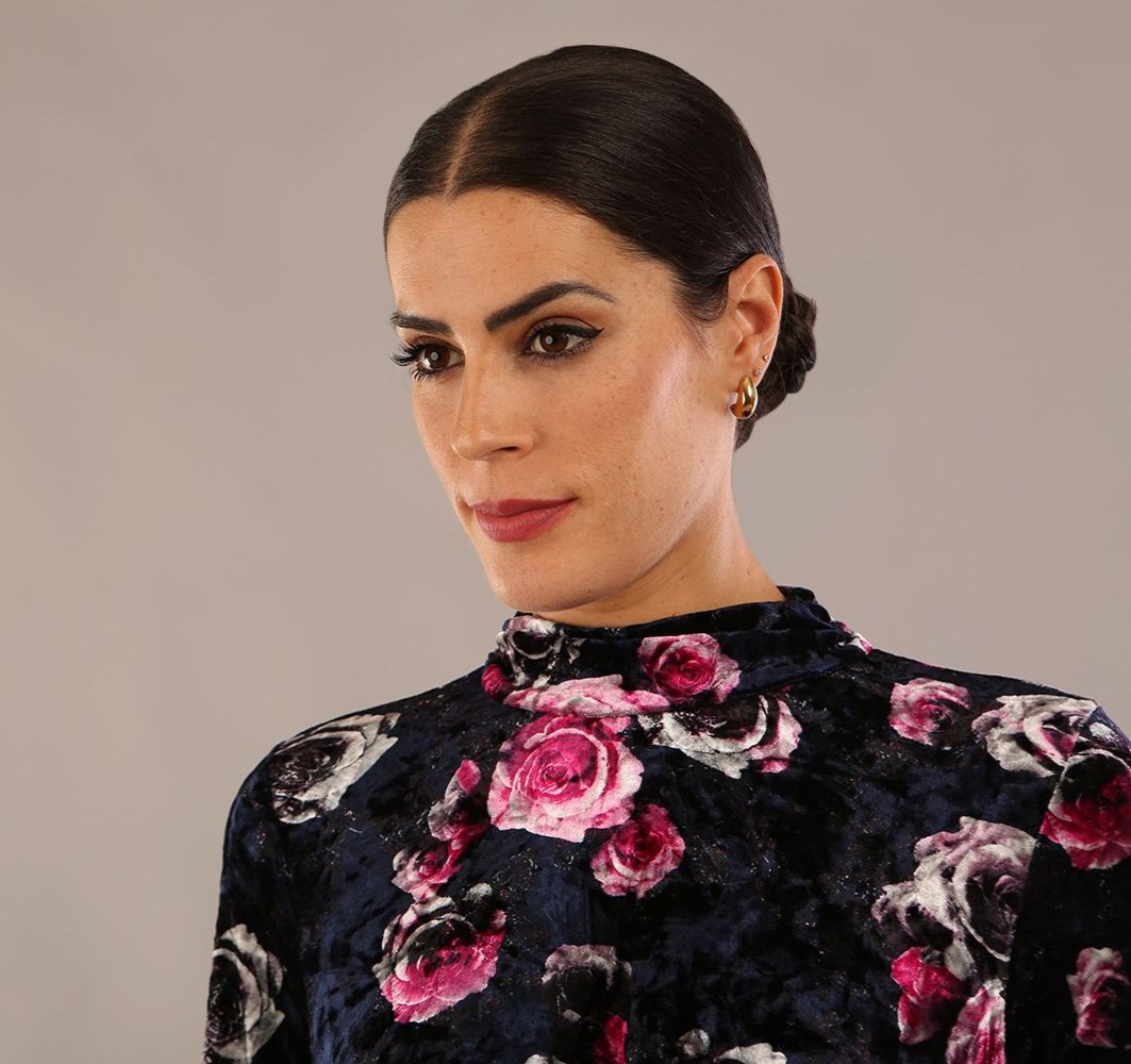 model is wearing a diva catwalk Firenze High-Neck Floral Velvet Wrap Dress long sleeves knee length with ruched sides.