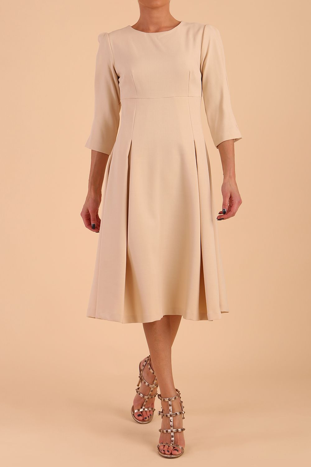model is wearing diva catwalk harpsden a-line skirt 3/4 sleeve swing dress with rounded neckline in sandshell beige front