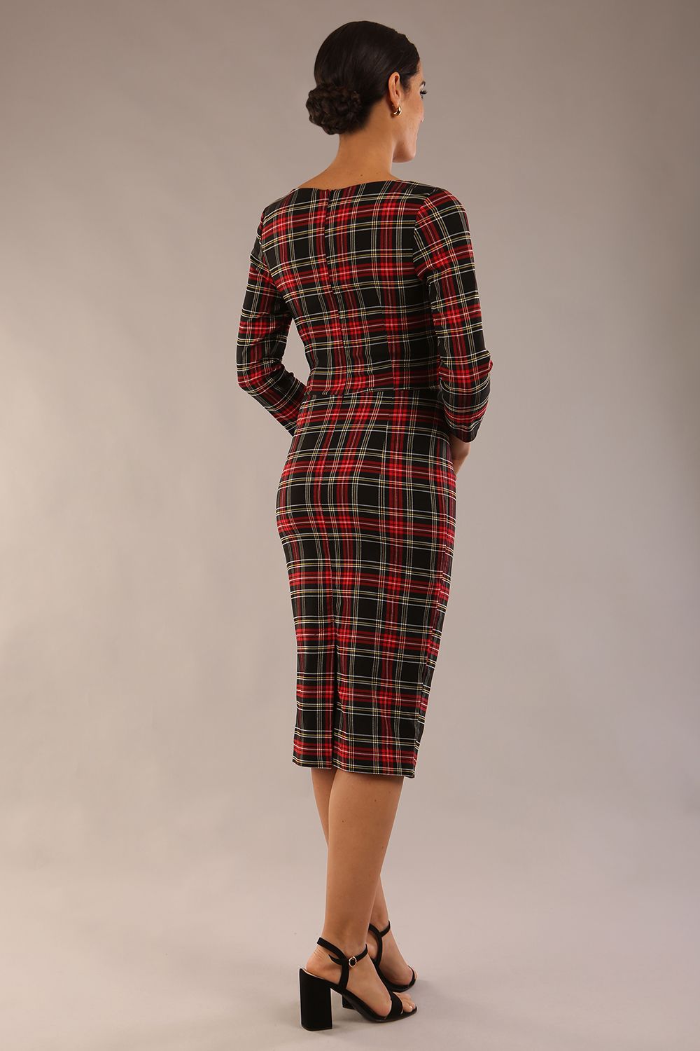 model is wearing a diva catwalk Horizon Tartan Stretch Pencil Dress with crossover v neckline and 3/4 sleeves and pleating details and knee length in luxury tartan stretch fabric in Royal Red Tartan