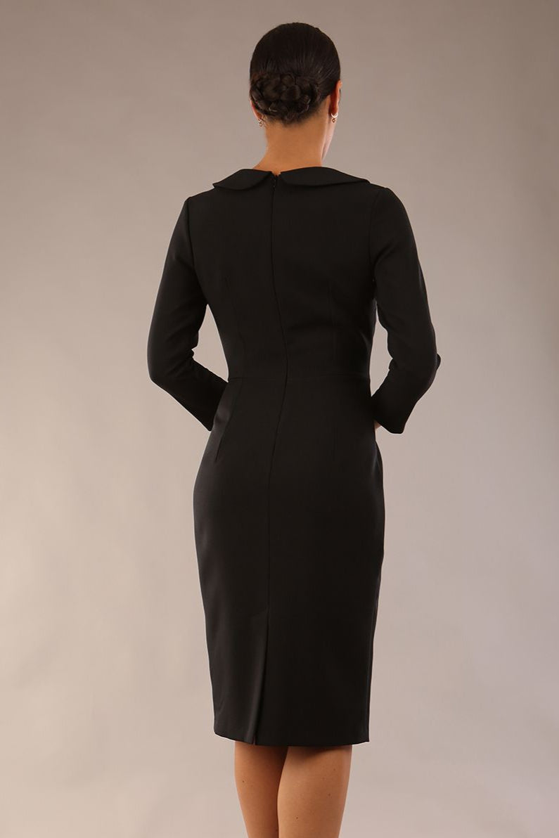 model wearing a diva catwalk  Helium 3/4 Sleeved Pencil Dress with 3/4 sleeve and knee length and bow detail on the neckline in black colour