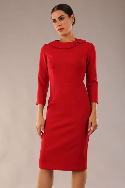 brunette model is wearing a diva catwalk  Helium 3/4 Sleeved Pencil Dress with 3/4 sleeve and knee length and bow detail on the neckline in dark red colour front close up