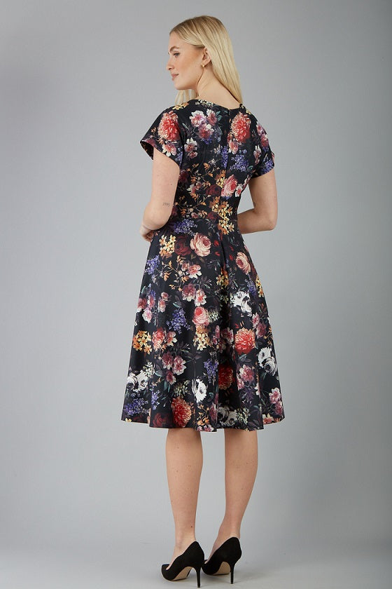 blonde model is wearing diva catwalk boston short sleeve v-neckline a-line swing dress in dark floral print front