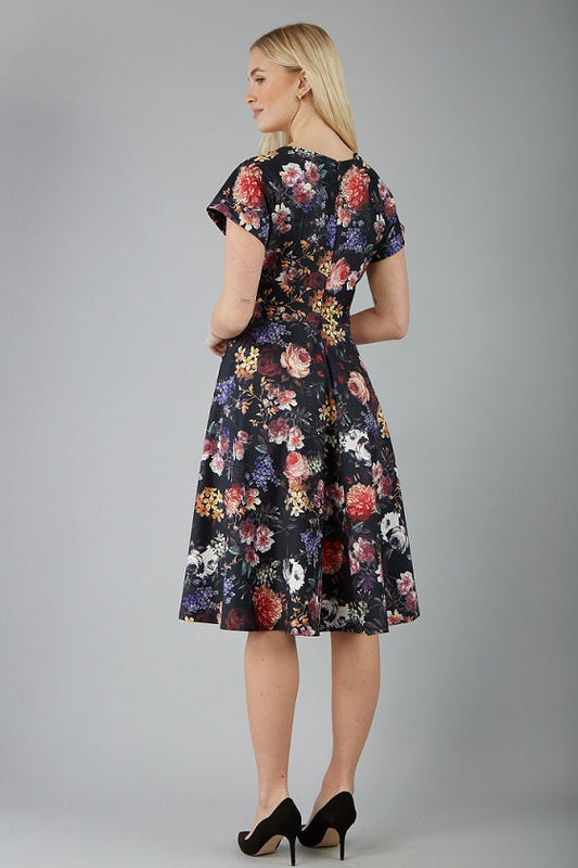 blonde model is wearing diva catwalk boston short sleeve v-neckline a-line swing dress in dark floral print front