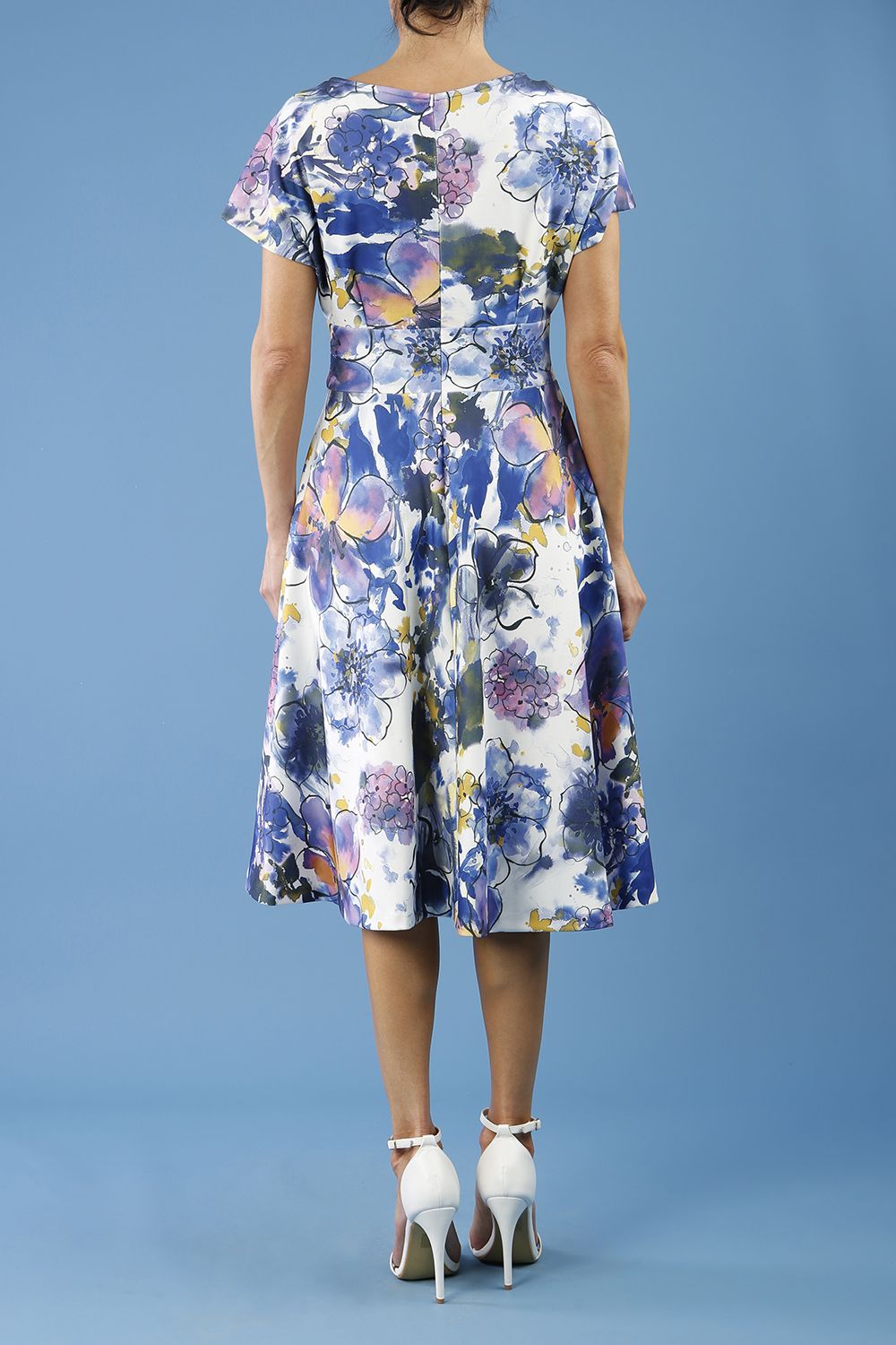 blonde model is wearing diva catwalk boston short sleeve v-neckline a-line swing dress in abstract hibiscus print back
