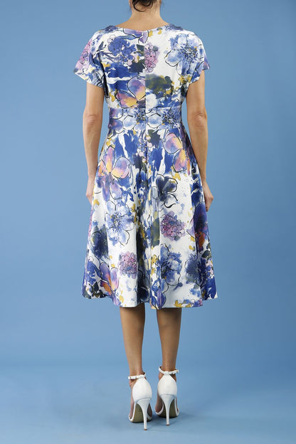blonde model is wearing diva catwalk boston short sleeve v-neckline a-line swing dress in abstract hibiscus print back