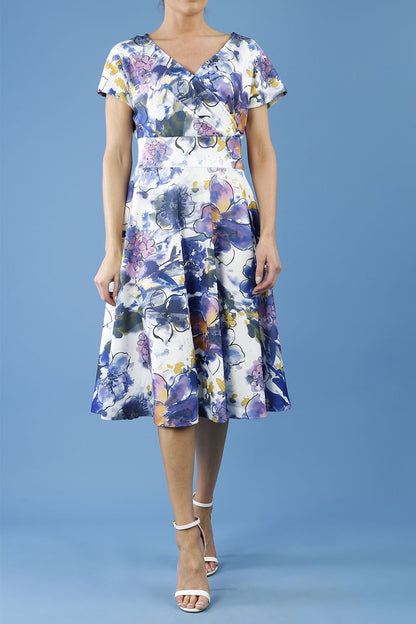 blonde model is wearing diva catwalk boston short sleeve v-neckline a-line swing dress in abstract hibiscus print back