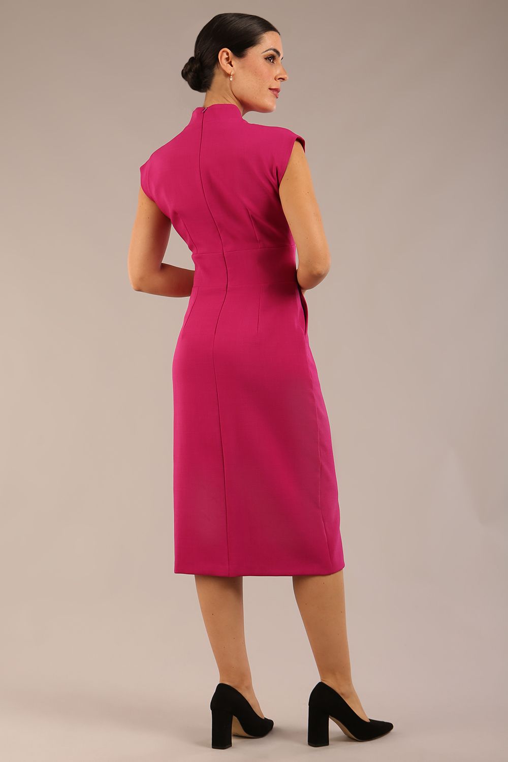 brunette Model is wearing a diva catwalk Derby pencil skirt dress cap sleeves with buttons details at the waistband and star neckline below the knee length with pockets in magenta colour front image (Magenta)