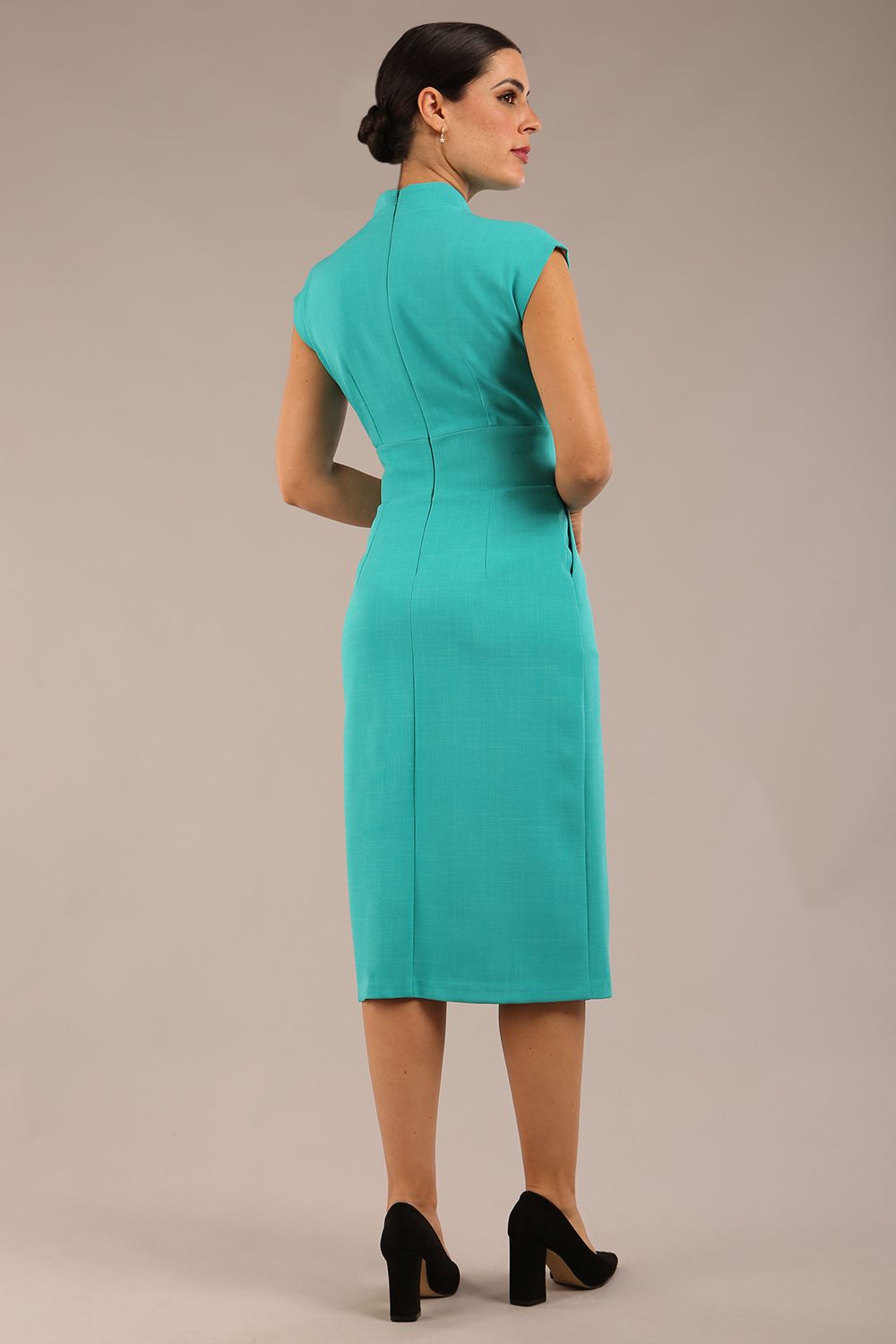 brunette Model is wearing a diva catwalk Derby pencil skirt dress cap sleeves with buttons details at the waistband and star neckline below the knee length with pockets in aqua green colour front image
