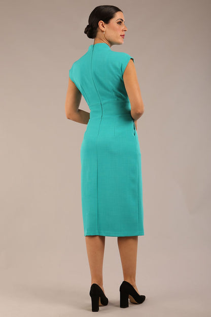 brunette Model is wearing a diva catwalk Derby pencil skirt dress cap sleeves with buttons details at the waistband and star neckline below the knee length with pockets in aqua green colour front image