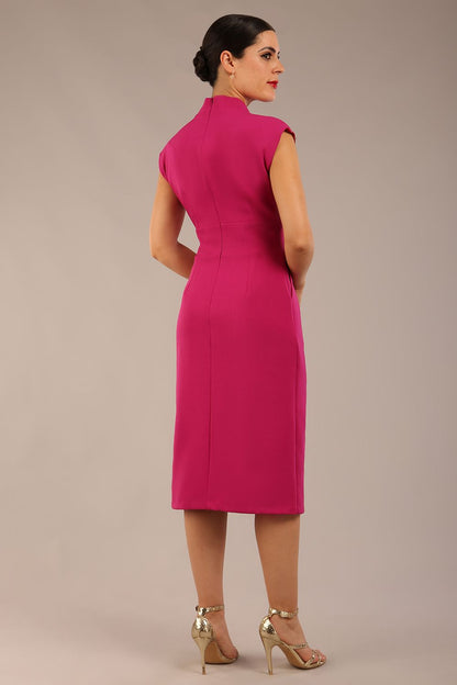 brunette Model is wearing a diva catwalk Derby pencil skirt dress cap sleeves with buttons details at the waistband and star neckline below the knee length with pockets in magenta colour front image (Magenta)