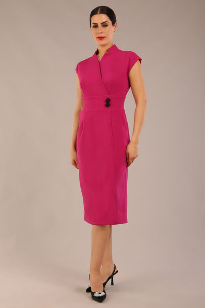 brunette Model is wearing a diva catwalk Derby pencil skirt dress cap sleeves with buttons details at the waistband and star neckline below the knee length with pockets in magenta colour front image (Magenta)