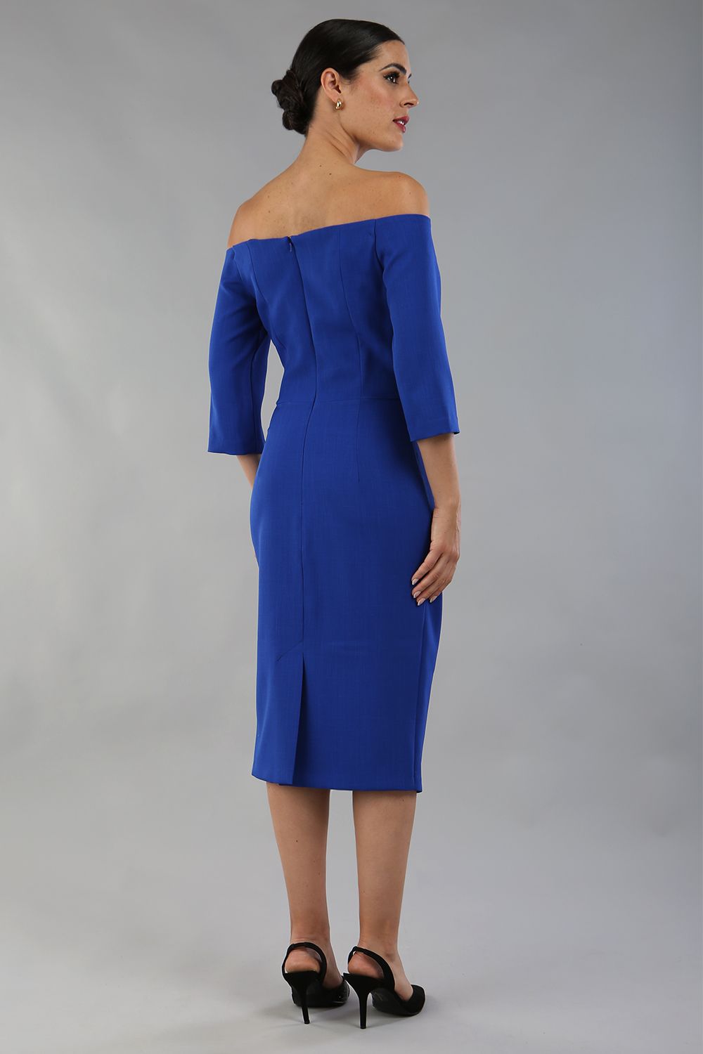 brunette model is wearing a diva catwalk lauren off shoulder asymmetric neckline pencil dress with sleeves in cobalt blue front 