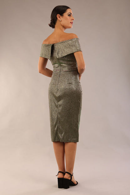 brunette model is wearing diva catwalk starlight tulip wrapped skirt woth off shoulder detail in sherwood gold glitter fabric front