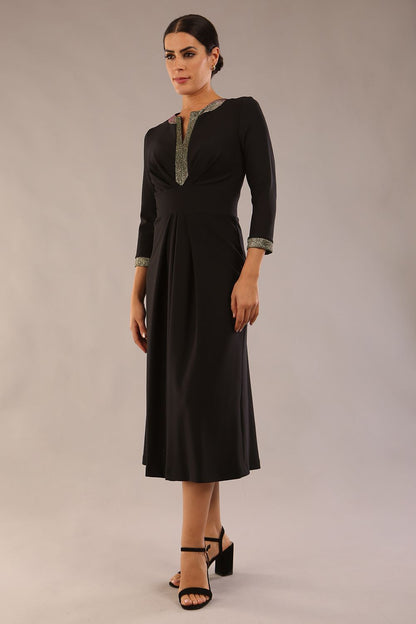 model is wearing diva catwalk carolyn swing midi dress with a band and sherwood glitter detail on sleeves and around the neckline in black colour front