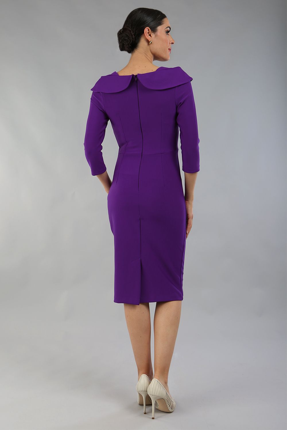 brunette model is wearing diva catwalk pencil dress with collar and a button detail on a side with 3/4 sleeve in passion purple front