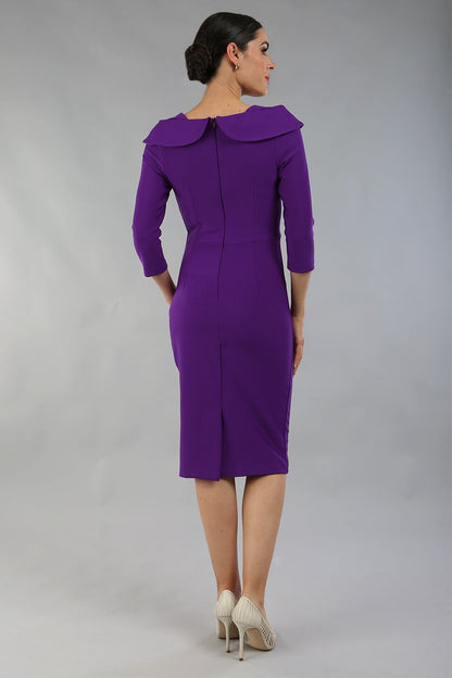 brunette model is wearing diva catwalk pencil dress with collar and a button detail on a side with 3/4 sleeve in passion purple front