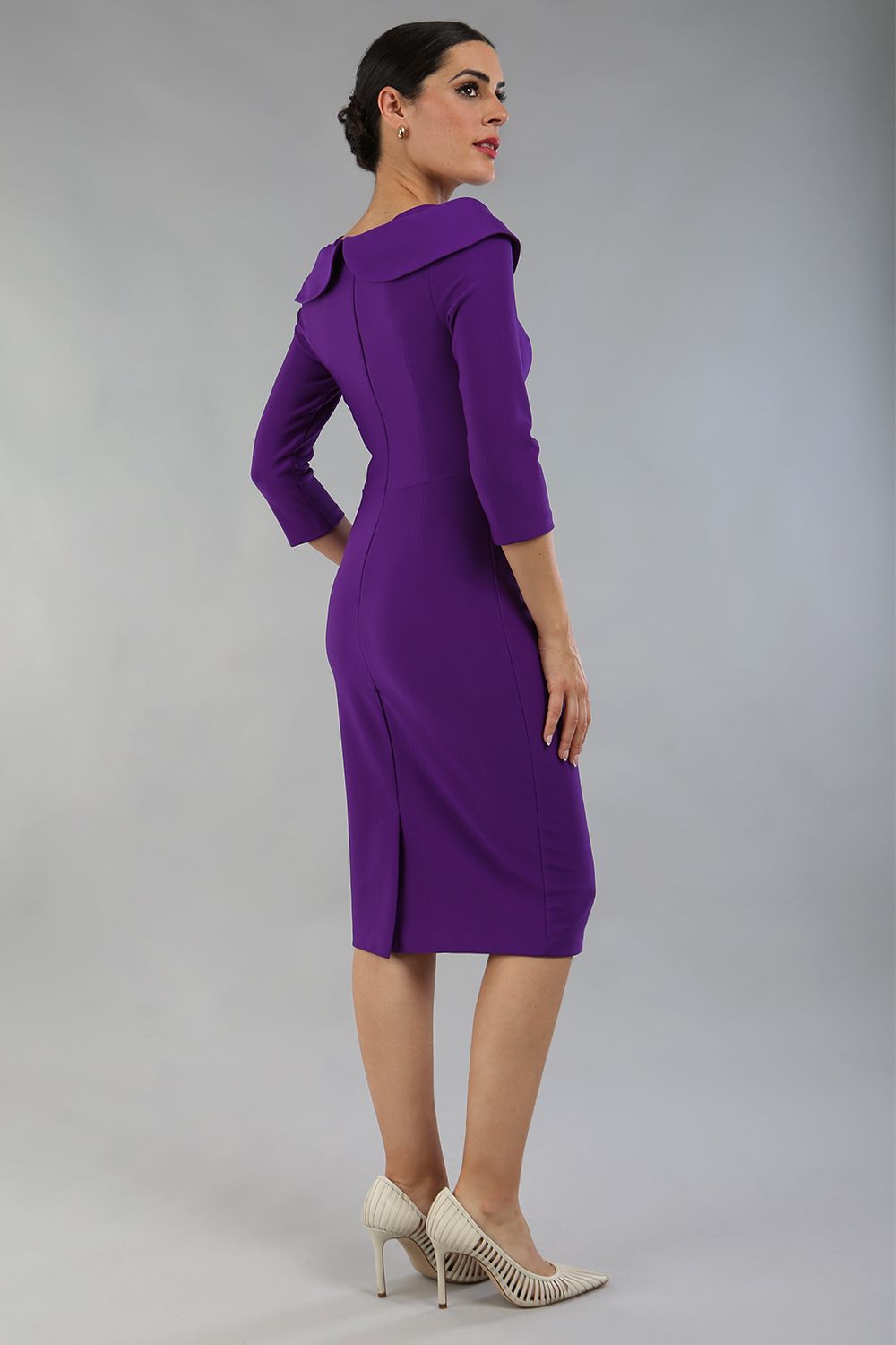 brunette model is wearing diva catwalk pencil dress with collar and a button detail on a side with 3/4 sleeve in passion purple front