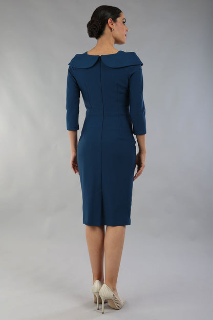 brunette model is wearing diva catwalk pencil dress with collar and a button detail on a side with 3/4 sleeve in glorious teal front close up