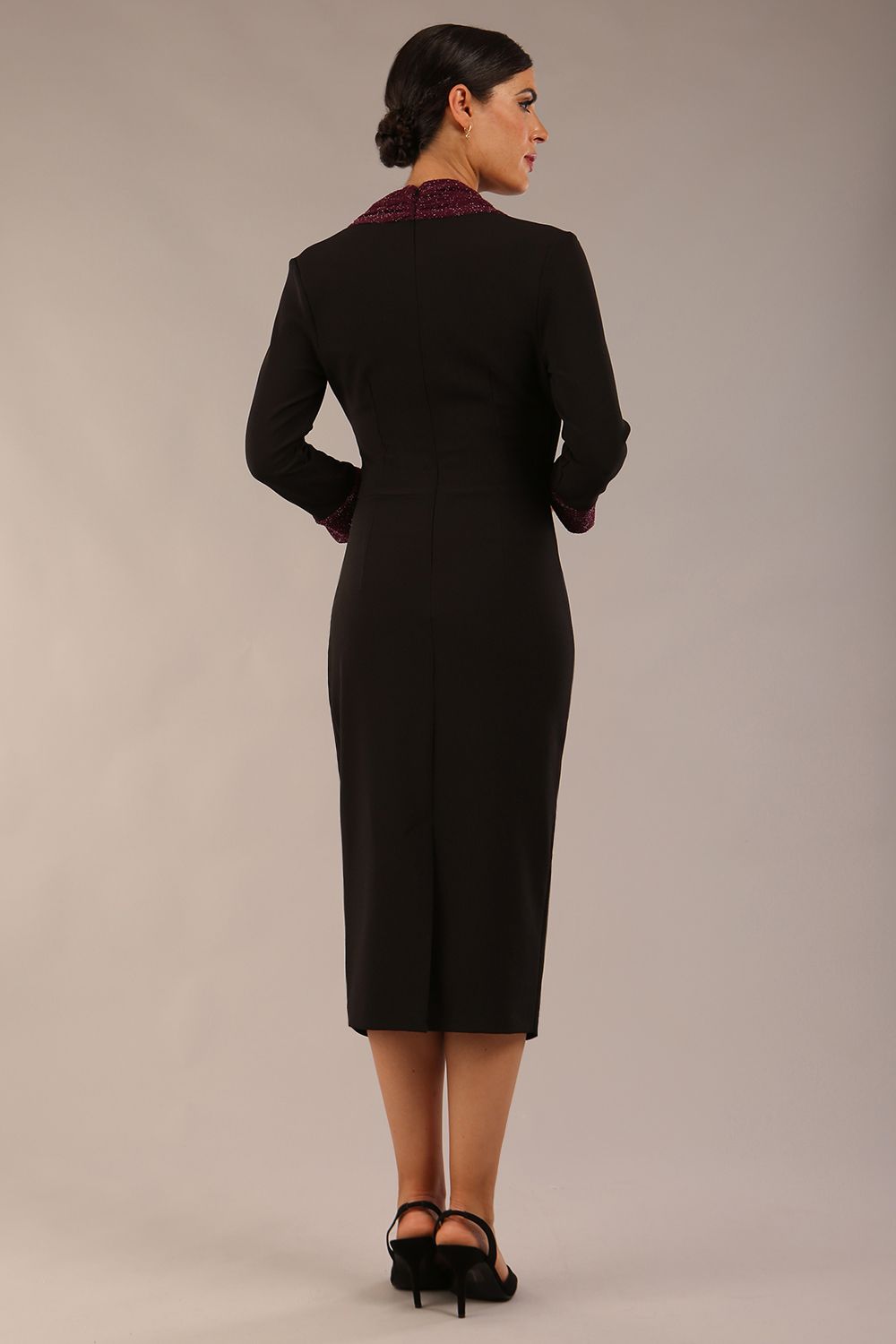 model is wearing diva catwalk osaka black pencil dress with burgundy sparkle contrasting detail on sleeves and v-neckline and knee length