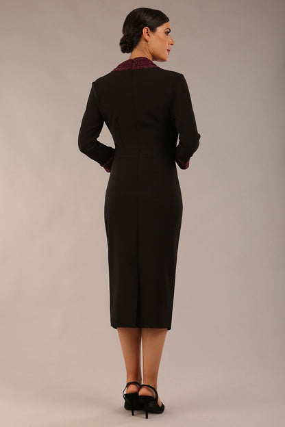 model is wearing diva catwalk osaka black pencil dress with burgundy sparkle contrasting detail on sleeves and v-neckline and knee length