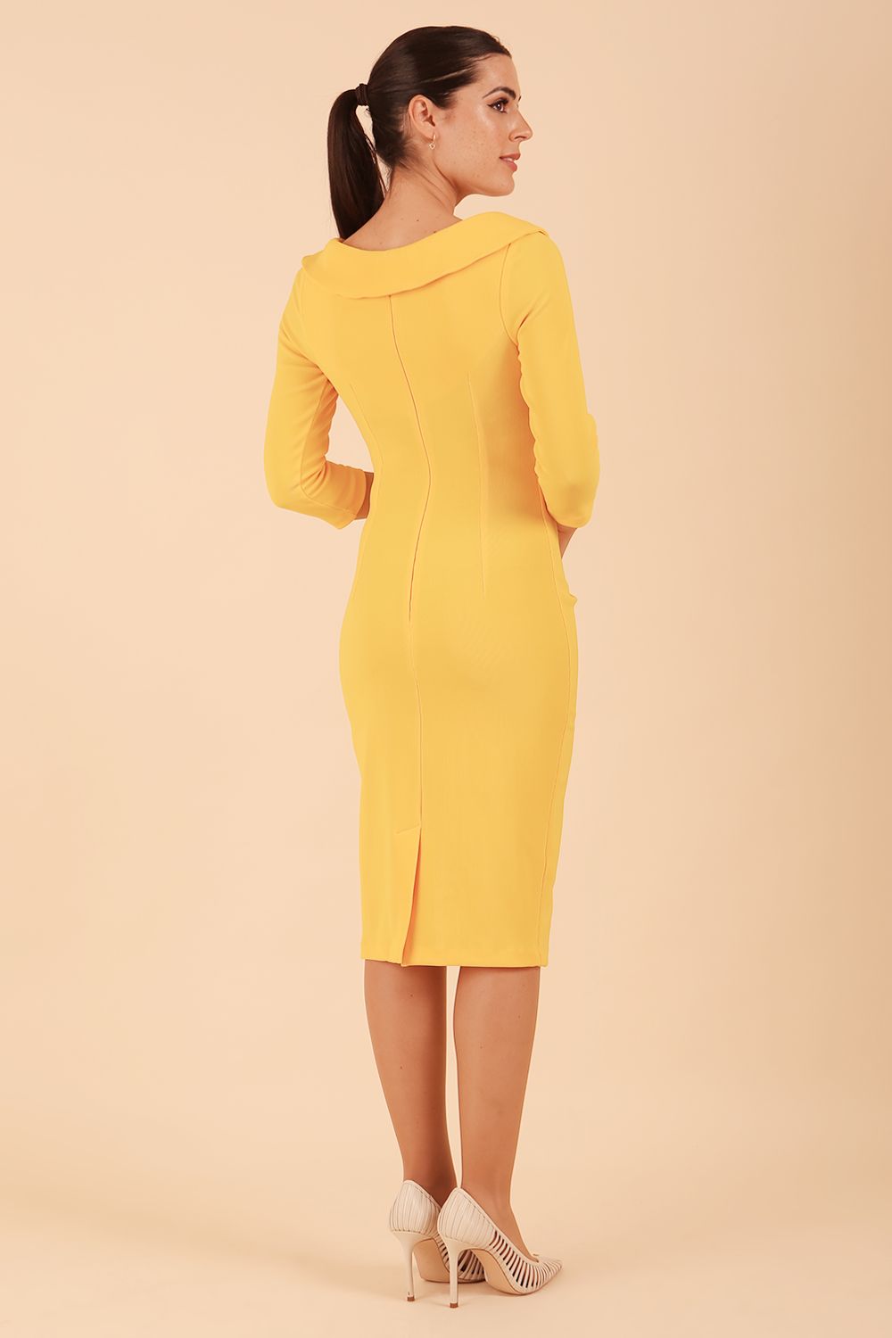 Model wearing diva catwalk Monique 3/4 Sleeve Pencil Dress with Overlapping Folded Round Neckline and 3/4 sleeves and knee length in Sunshine Yellow front